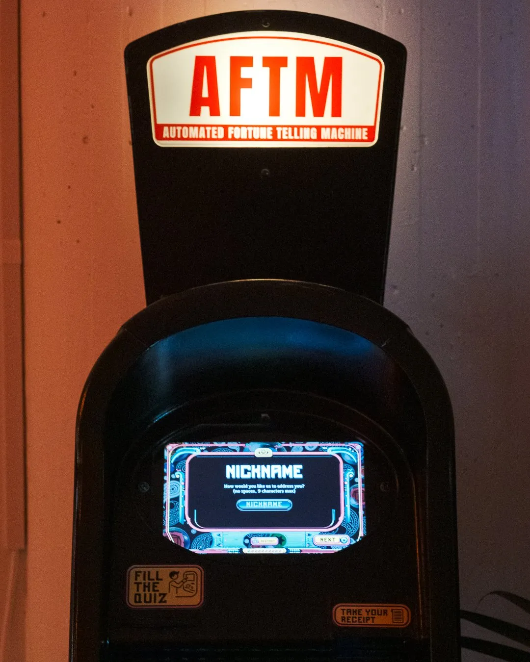 An AFTM, a repurposed ATM wrapped in paisley, with a glowing marquee