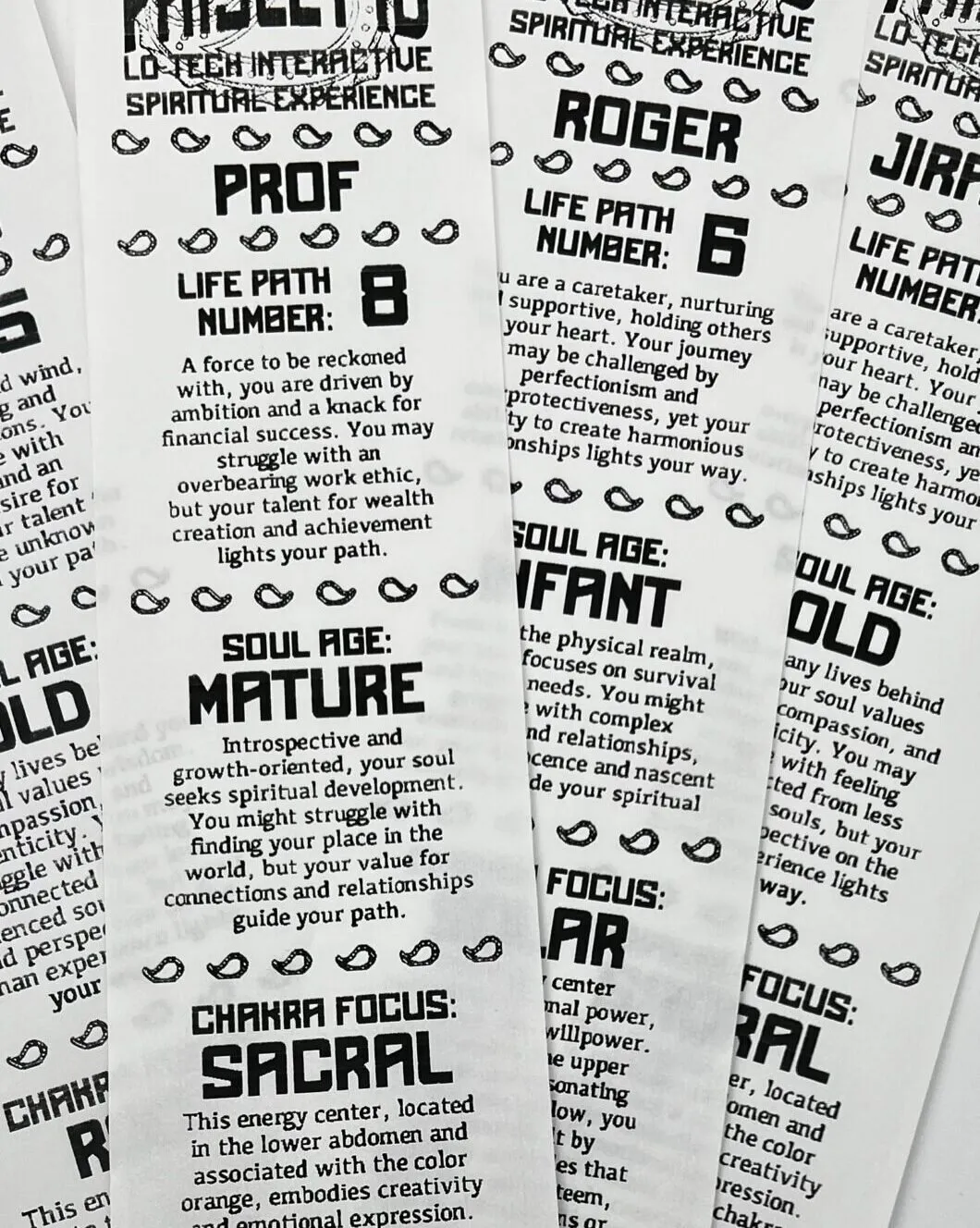 A stack of printed fortune tickets showing Life Path Number, Soul Age and Chakra Focus