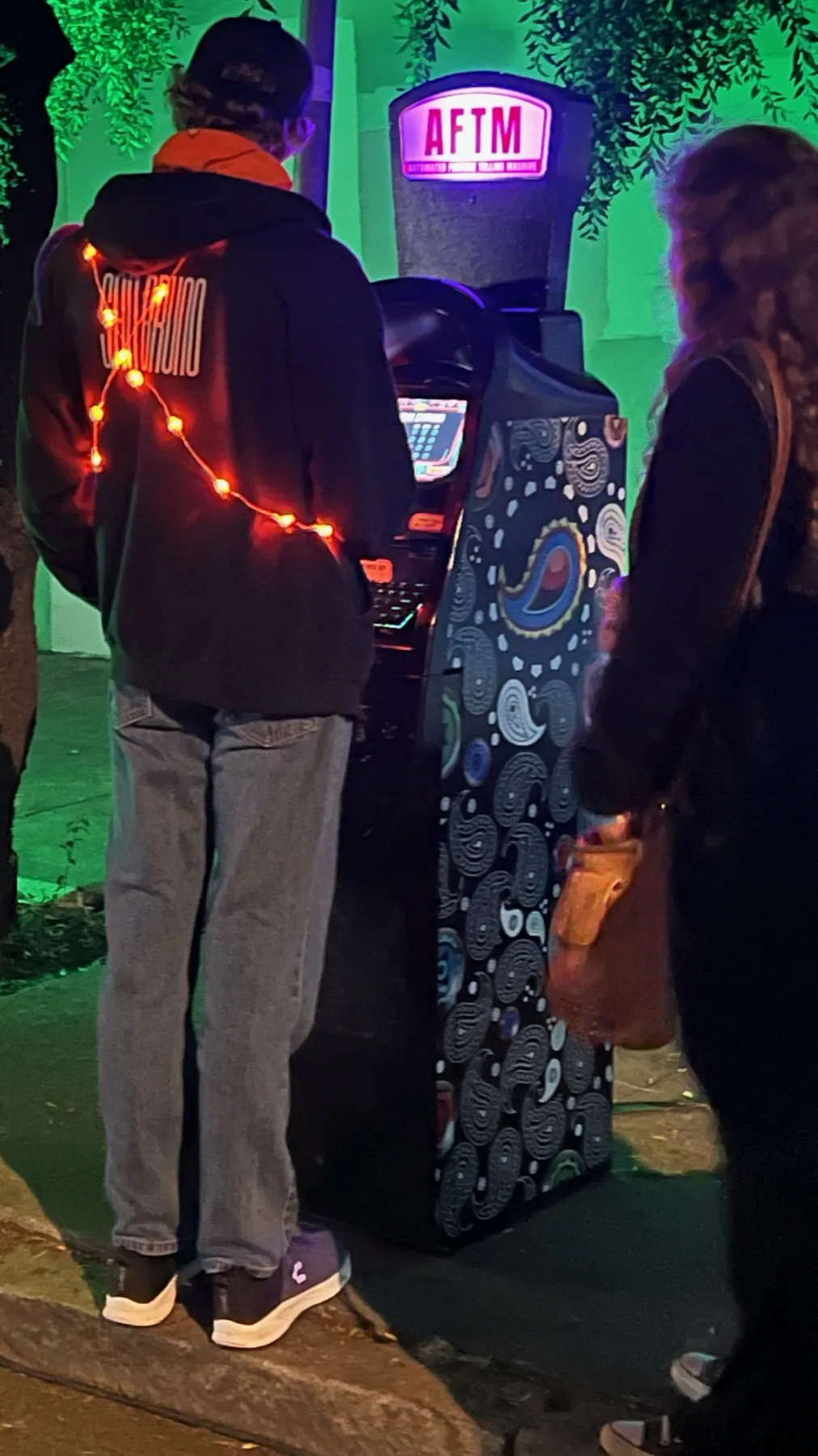 A guest at an AFTM under string lights