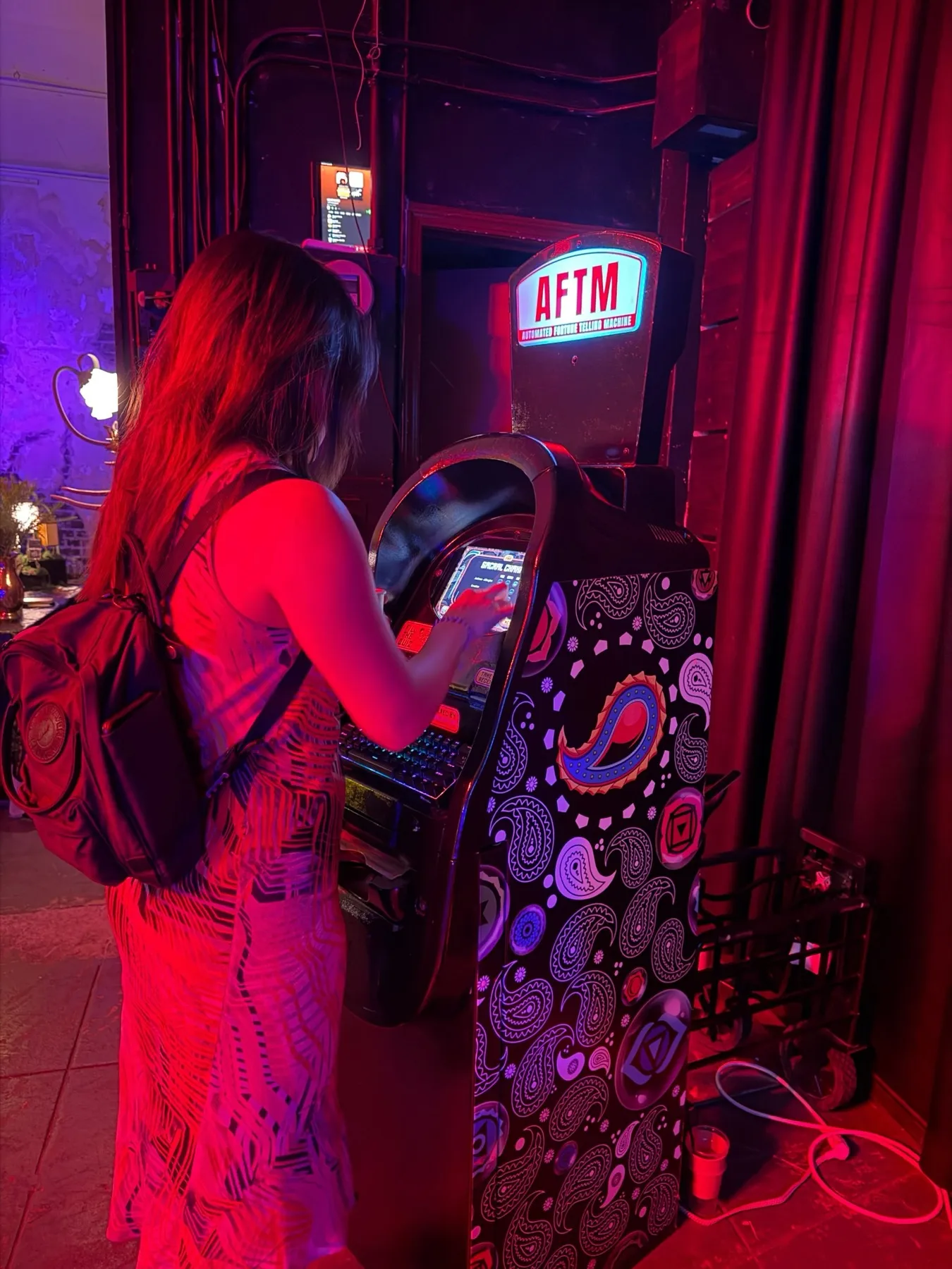 A guest taking the quiz at the AFTM in red and purple light