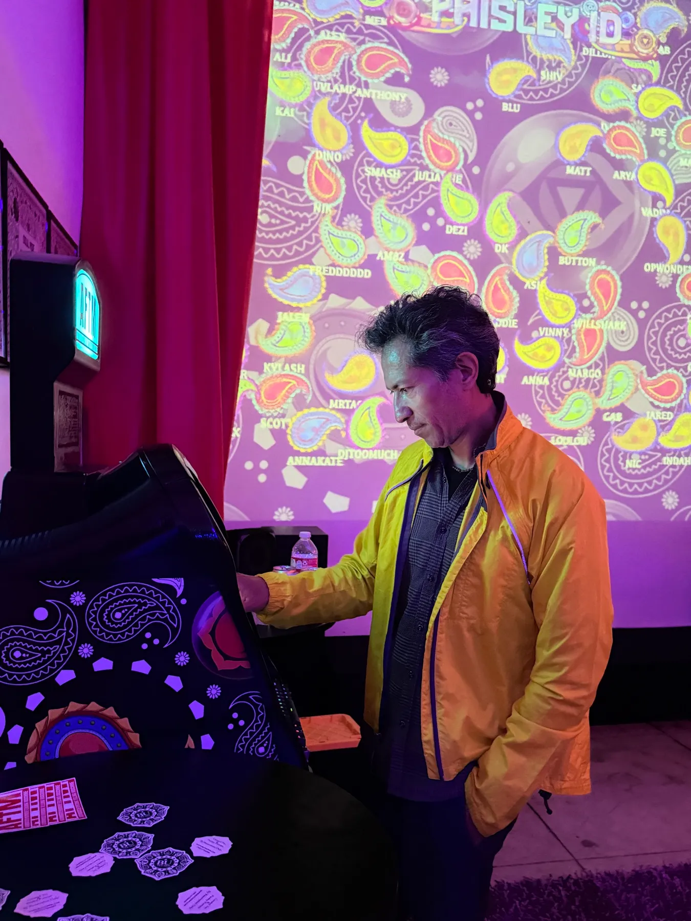 A guest at the AFTM in front of a paisley projection at Cre8